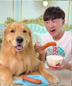 Sharing a snack with the golden retriever